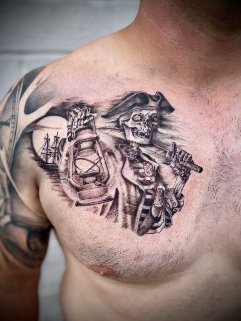 Black and grey chest tattoo by Sideshow Tattoo and Piercing San Diego