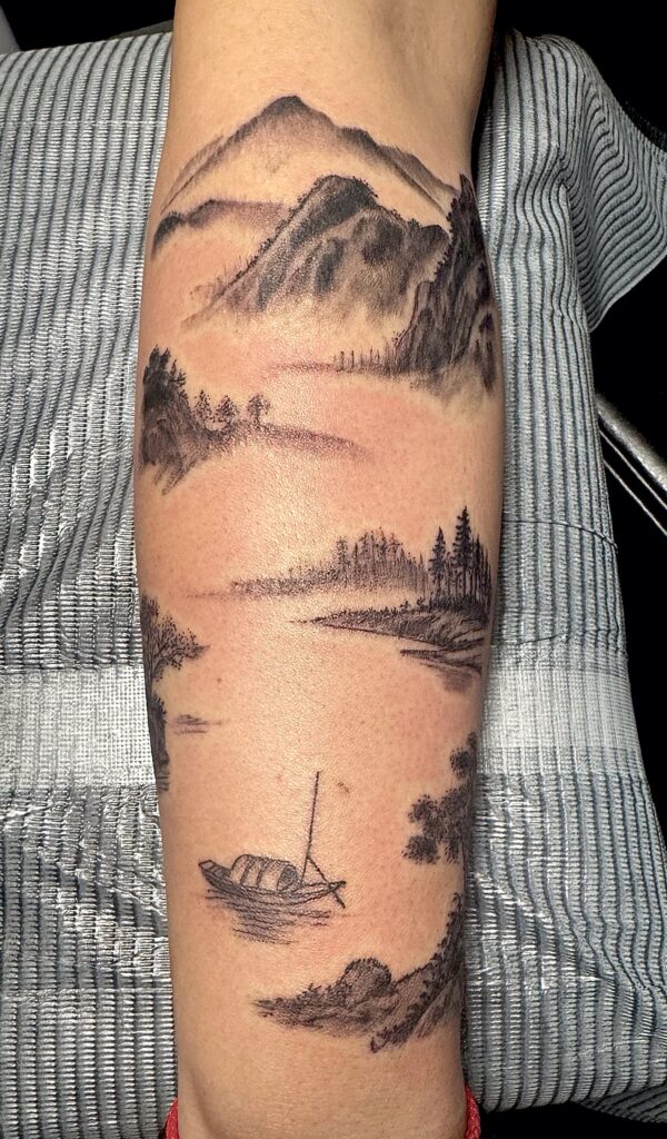 Black and grey landscape tattoo with boat on forearm by Sideshow Tattoo and Piercing San Diego